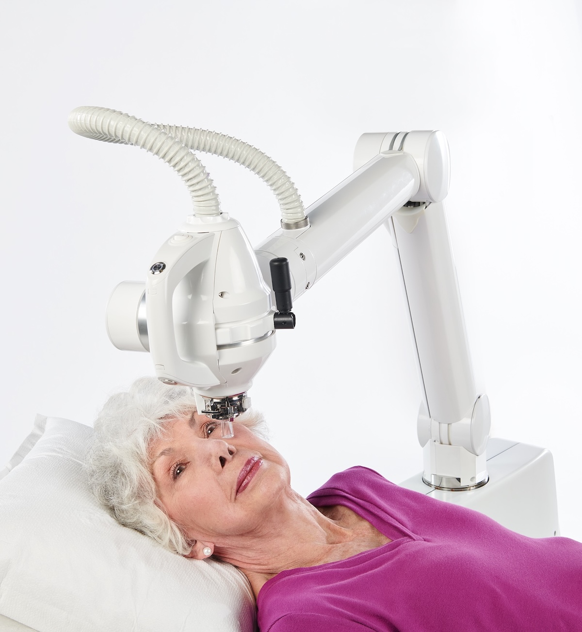 Female patient receiving treatment using the Radiant system in a clinical setting